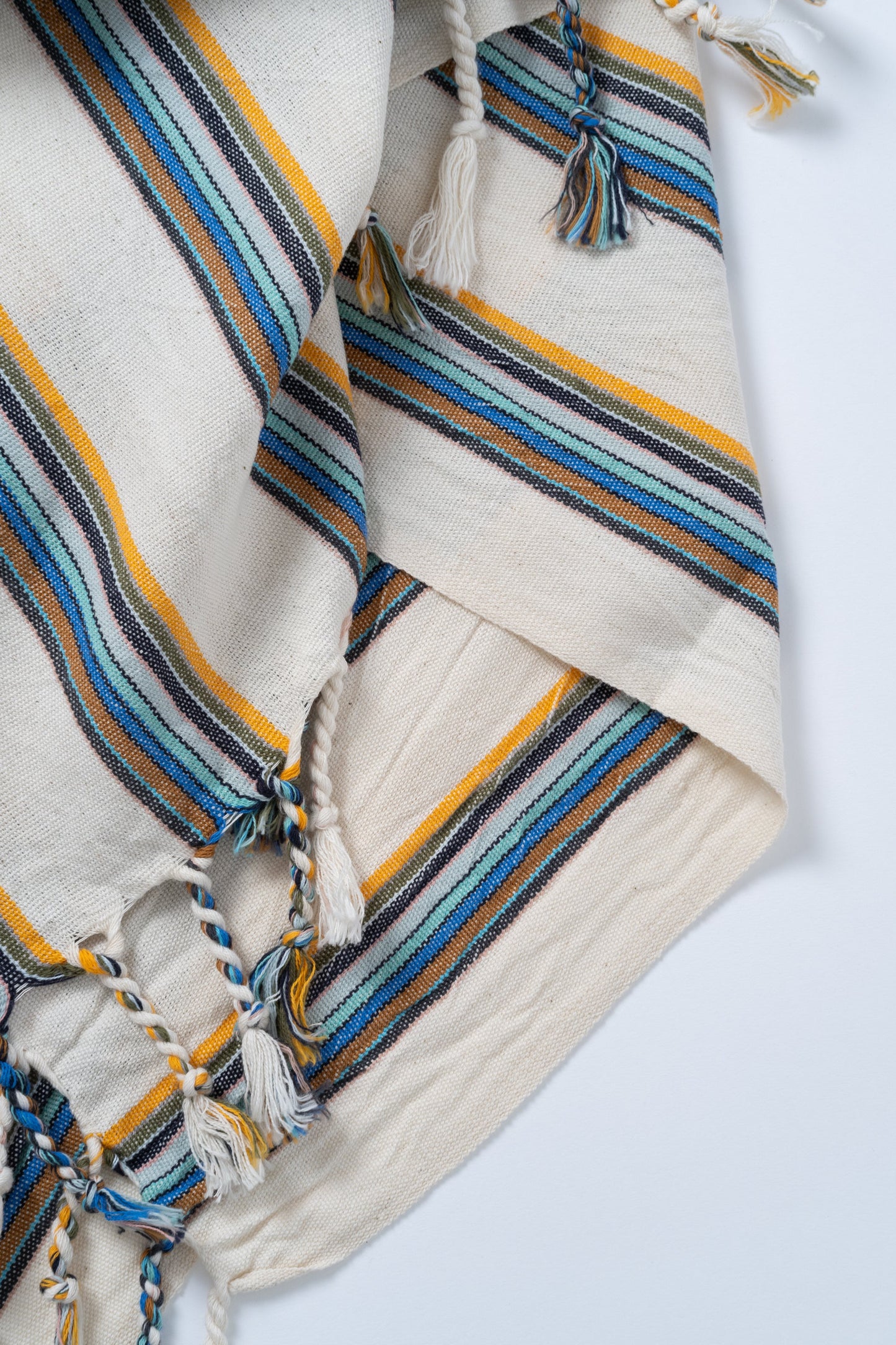 Striped fabric with blue, yellow, and brown patterns on a white background