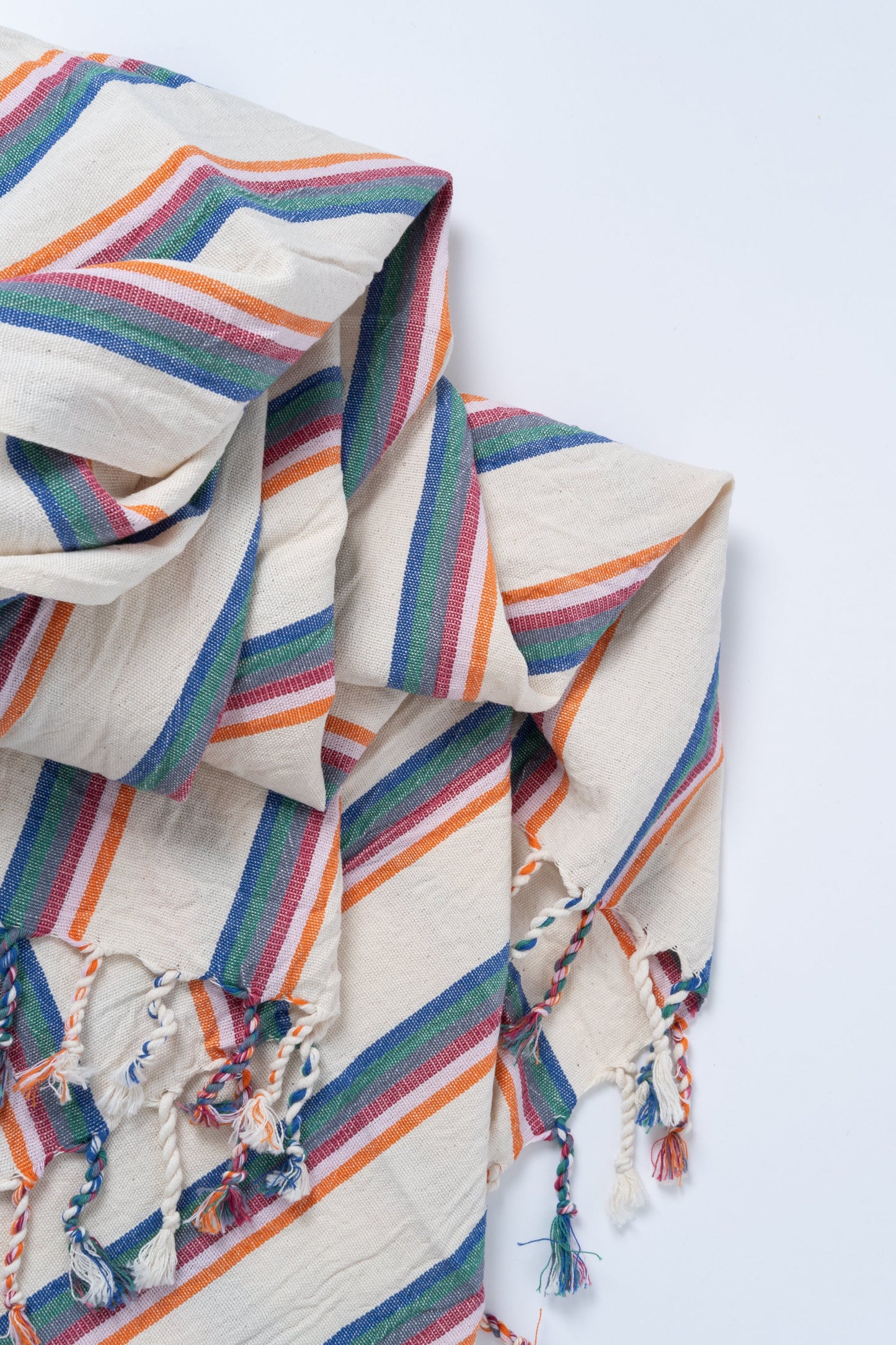 Colorful striped fabric with embroidered patterns on a white background