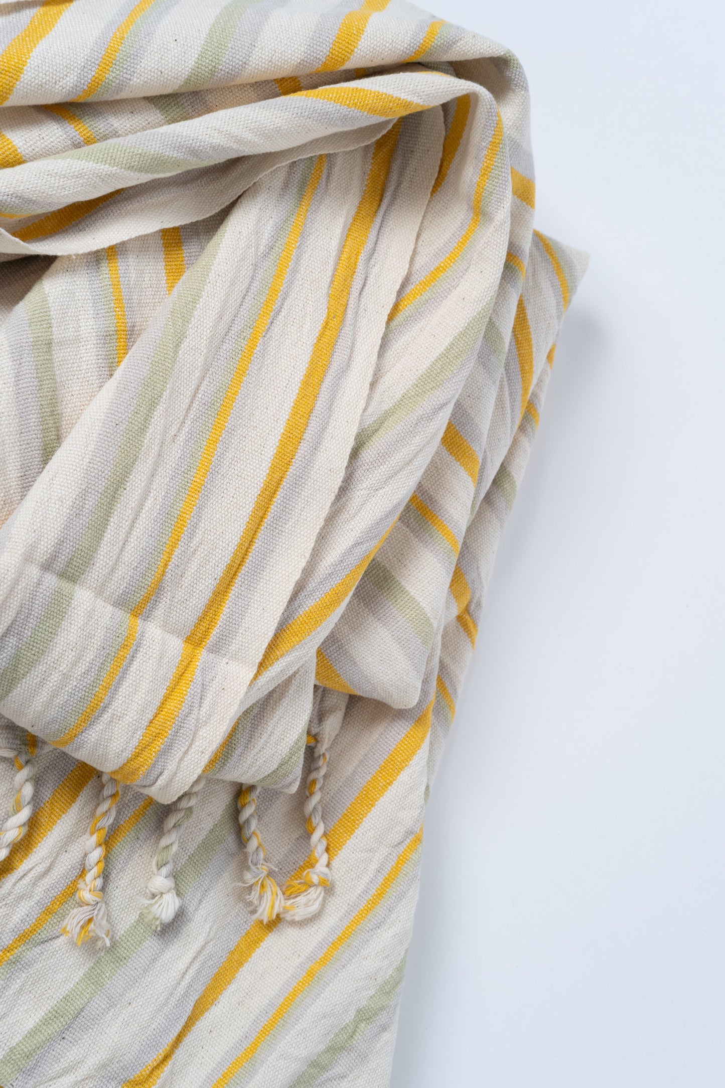 Striped fabric with yellow and beige lines on a light gray background