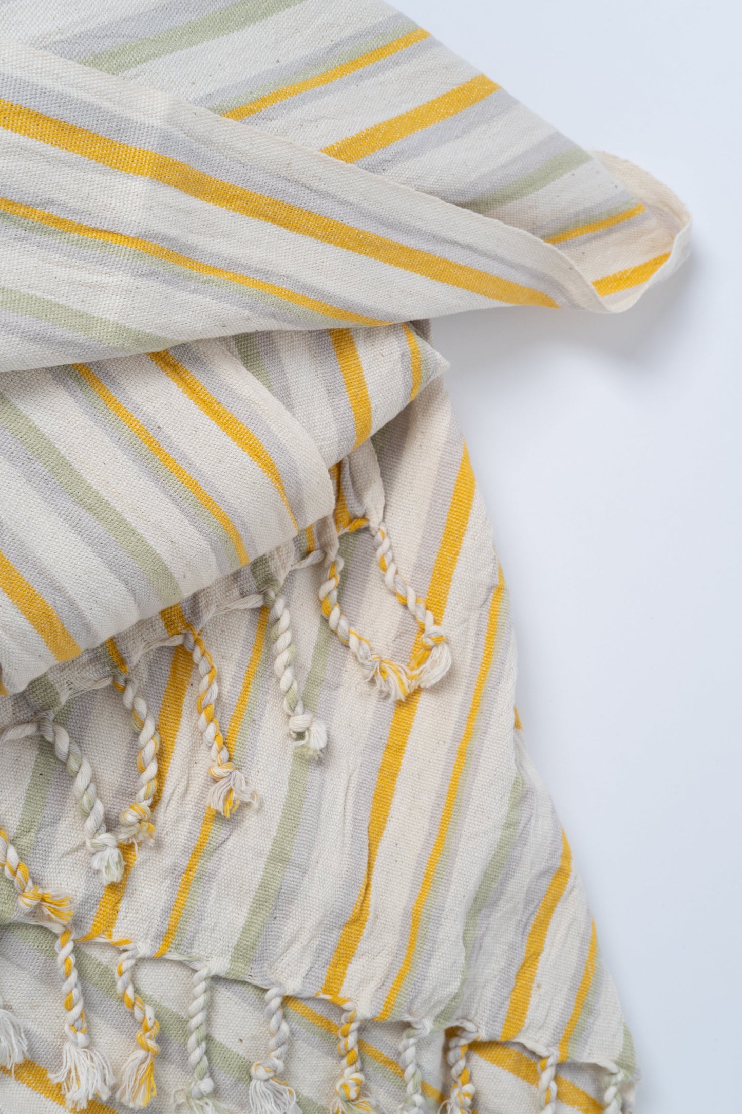 Textile with yellow and beige stripes on a white background