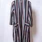 Striped robe hanging on a white background