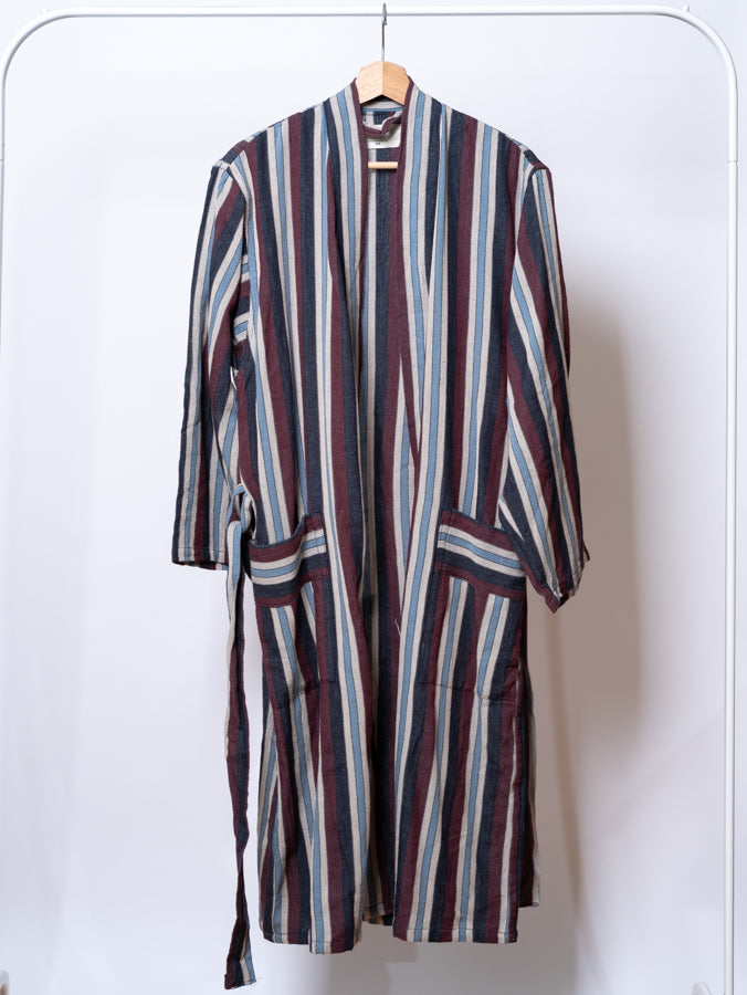 Striped robe hanging on a white background