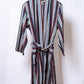Striped robe on a hanger against a white background