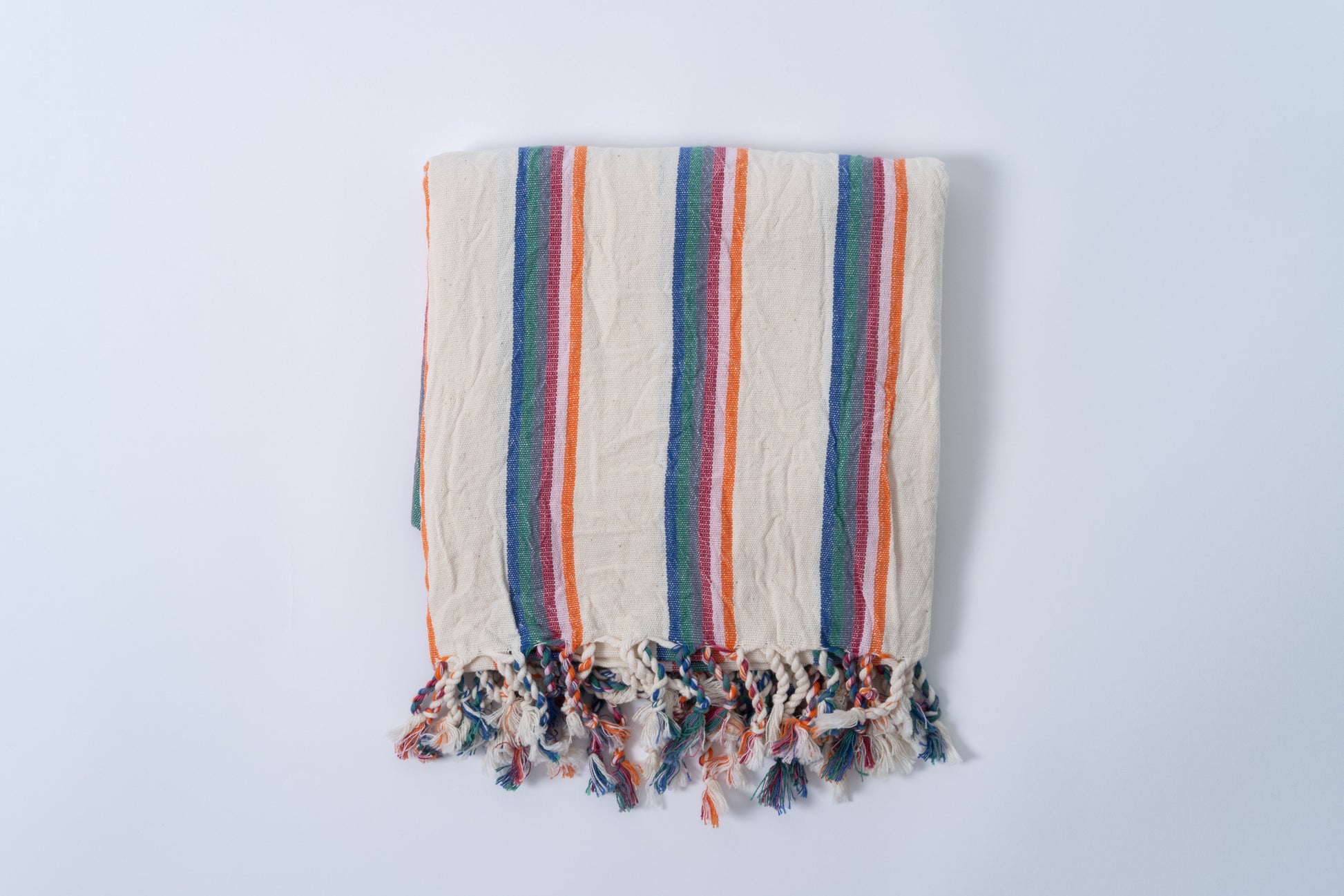 Striped towel with colorful border on a light gray background