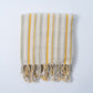 Striped towel with yellow and gray stripes on a white background