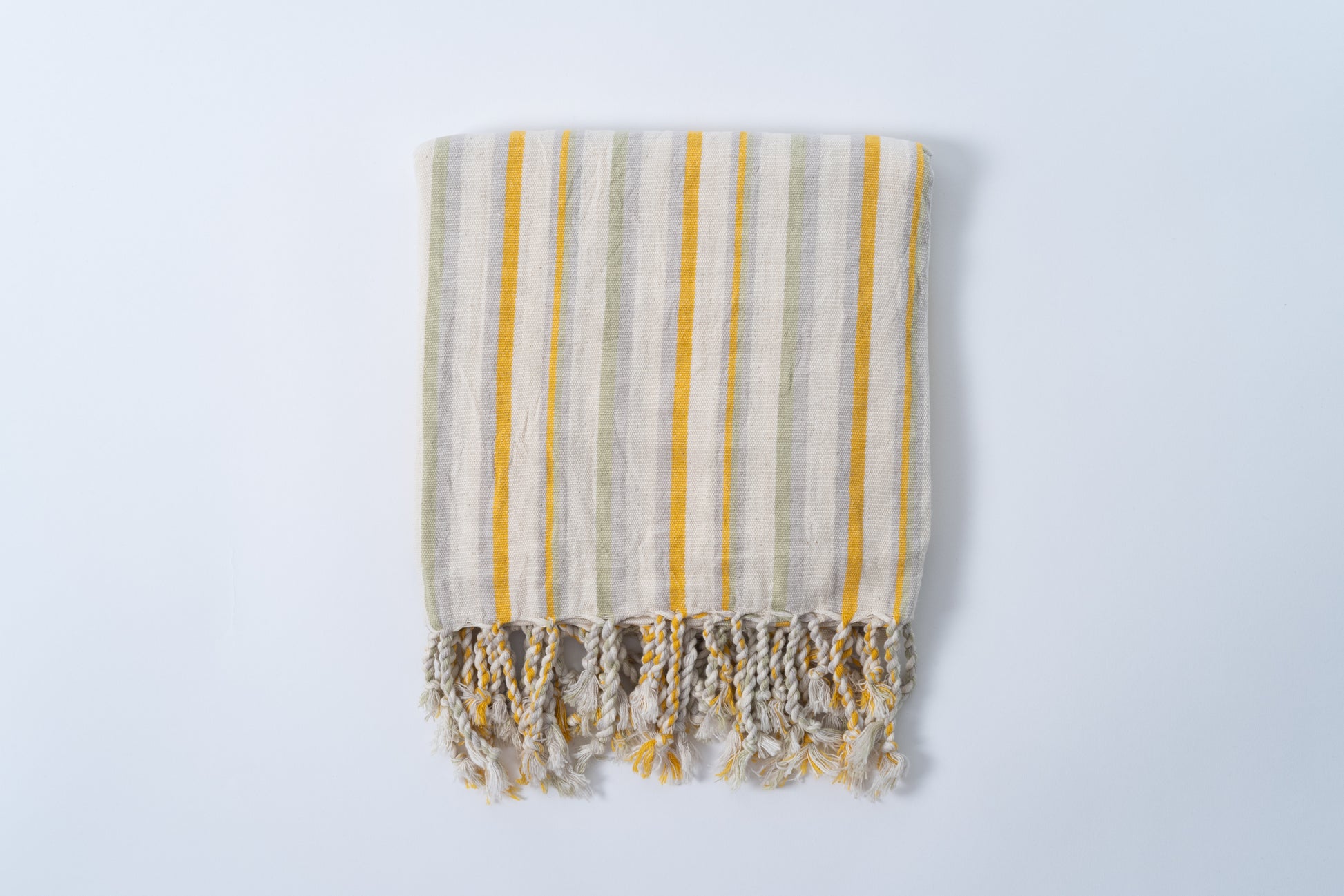 Striped towel with yellow and gray stripes on a white background