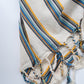 Striped drawstring bag with blue, yellow, and gray colors on a white background