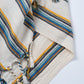 Striped fabric with blue, yellow, and brown patterns on a white background