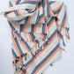 Striped fabric bag with colorful patterns on a white background